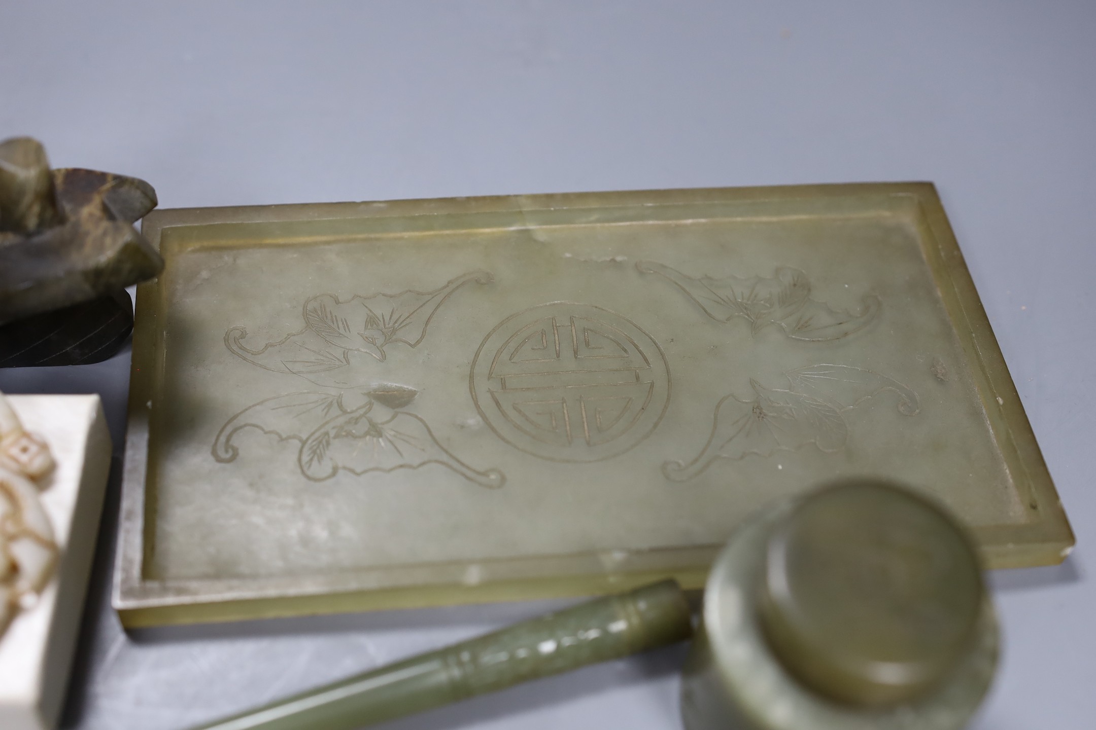 A Chinese bowenite jade desk set (7) and a plaque, model of junk 16cms high